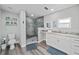 Bright bathroom featuring a glass shower, wood-look flooring, and vanity with light countertops at 3416 Crape Myrtle Dr, Hernando Beach, FL 34607