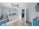 Cozy bedroom with bunk beds, ceiling fan, and gray toned decor and wood-look floors at 3416 Crape Myrtle Dr, Hernando Beach, FL 34607