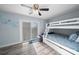 Light-filled bedroom with a bunk bed, wood-look floors, and sliding glass doors to a balcony at 3416 Crape Myrtle Dr, Hernando Beach, FL 34607