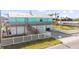 Attractive two-story coastal home with a spacious deck and ample parking behind a white fence at 3416 Crape Myrtle Dr, Hernando Beach, FL 34607