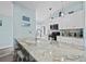 This stylish kitchen features granite countertops, pendant lights, and ample seating at the island at 3416 Crape Myrtle Dr, Hernando Beach, FL 34607