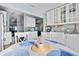 Bright kitchen boasts white cabinetry, stone countertops, and a seamless view into other living spaces at 3416 Crape Myrtle Dr, Hernando Beach, FL 34607