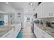 Modern kitchen with stainless steel appliances, granite countertops, and ample cabinet space at 3416 Crape Myrtle Dr, Hernando Beach, FL 34607