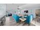 Comfortable living room with blue sofas, modern decor, and wood-look floors throughout the home at 3416 Crape Myrtle Dr, Hernando Beach, FL 34607