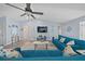 Spacious living room featuring contemporary decor, ceiling fan, and wood-look flooring at 3416 Crape Myrtle Dr, Hernando Beach, FL 34607
