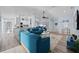 Open-concept living room featuring bright blue sofas and wood-look floors in a modern home at 3416 Crape Myrtle Dr, Hernando Beach, FL 34607