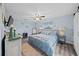 Comfortable bedroom with ceiling fan, soft lighting, and wood-look laminate flooring at 3416 Crape Myrtle Dr, Hernando Beach, FL 34607