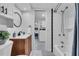 Bright bathroom featuring a shower/tub combo, wood vanity and black and white patterned flooring at 3608 Water St, Ellenton, FL 34222