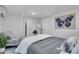 Bedroom with white walls, grey bedding, butterfly art and a sitting area with light blue cushions at 3608 Water St, Ellenton, FL 34222