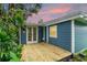 Charming blue home with a wooden deck and lush landscaping at 3608 Water St, Ellenton, FL 34222
