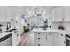 Well-lit kitchen showcases white cabinets, stainless steel appliances, and an open layout to the living area at 3608 Water St, Ellenton, FL 34222