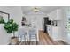 Modern white kitchen with breakfast bar and stainless steel appliances at 3608 Water St, Ellenton, FL 34222