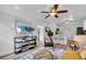 Bright living room with a ceiling fan that opens to the kitchen at 3608 Water St, Ellenton, FL 34222