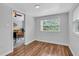 Bright room with wood floors, a window and a view to the gold-themed room at 3608 Water St, Ellenton, FL 34222