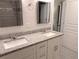 Bathroom featuring a dual sink with granite countertop, white cabinets, and walk-in shower at 3744 Lake Bayshore Dr # K-503, Bradenton, FL 34205