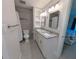 Bathroom featuring a walk-in shower, neutral tile, granite counter and dual mirrors at 3744 Lake Bayshore Dr # K-503, Bradenton, FL 34205