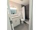 Modern bathroom with gray tile, granite countertop and well-lit vanity with decorative accents at 3744 Lake Bayshore Dr # K-503, Bradenton, FL 34205