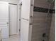 Bathroom with a walk-in shower, granite countertops, neutral tile, and linen closet at 3744 Lake Bayshore Dr # K-503, Bradenton, FL 34205