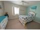 Bright bedroom with beach-themed bedding, white furniture, and cheerful turquoise accents at 3744 Lake Bayshore Dr # K-503, Bradenton, FL 34205