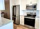This bright kitchen has new appliances, granite countertops, a decorative backsplash, and clean, white cabinets at 3744 Lake Bayshore Dr # K-503, Bradenton, FL 34205