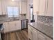 Updated kitchen features new appliances, granite countertops, modern fixtures, and ample cabinet space at 3744 Lake Bayshore Dr # K-503, Bradenton, FL 34205