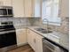 This well-appointed kitchen offers stainless steel appliances, granite countertops, and a mosaic tile backsplash at 3744 Lake Bayshore Dr # K-503, Bradenton, FL 34205