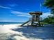 Lifeguard stand on a sunny beach with clear blue skies and calm waters at 3744 Lake Bayshore Dr # K-503, Bradenton, FL 34205