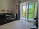 A living room with a modern entertainment center, balcony access, and sleek design, offering a contemporary living experience at 3744 Lake Bayshore Dr # K-503, Bradenton, FL 34205