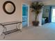 A living area featuring a decorative table, a large plant, and a glimpse into a bright bedroom, showcasing a stylish interior at 3744 Lake Bayshore Dr # K-503, Bradenton, FL 34205