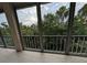 Enclosed, screened in patio with tiled floors and a view of tropical green foliage at 3744 Lake Bayshore Dr # K-503, Bradenton, FL 34205