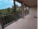 Relaxing screened-in patio with ceramic tile floors offering views of mature tree canopy at 3744 Lake Bayshore Dr # K-503, Bradenton, FL 34205