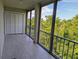 Screened porch with tile flooring and view of surrounding trees at 3744 Lake Bayshore Dr # K-503, Bradenton, FL 34205