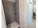 Walk-in shower featuring gray tile surround, overhead nozzle and decorative glass accents at 3744 Lake Bayshore Dr # K-503, Bradenton, FL 34205