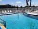 Refreshing swimming pool with clear blue water and comfortable lounge chairs by the poolside at 3744 Lake Bayshore Dr # K-503, Bradenton, FL 34205