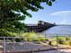 A train travels across a bridge over water, with lush vegetation visible in the foreground at 3744 Lake Bayshore Dr # K-503, Bradenton, FL 34205