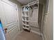 Walk-in closet featuring built in shelving, carpet and white walls at 3744 Lake Bayshore Dr # K-503, Bradenton, FL 34205