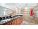 Bathroom features a double vanity, granite countertop, tile flooring, and a walk-in shower with tile surround at 3761 Countryside Rd, Sarasota, FL 34233