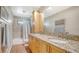 Bright bathroom featuring a large vanity with double sinks, granite countertops, tile floors and a shower at 3761 Countryside Rd, Sarasota, FL 34233