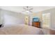 Bedroom featuring hardwood floors, a ceiling fan, a tv, and access to the ensuite bathroom at 3761 Countryside Rd, Sarasota, FL 34233