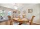 Dining room featuring a hardwood table, pendant lighting, and access to outdoor patio at 3761 Countryside Rd, Sarasota, FL 34233