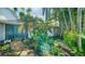 Landscaped walkway leading to the front entrance with lush tropical foliage at 3761 Countryside Rd, Sarasota, FL 34233