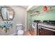 Laundry room with stainless steel washer and dryer, sink, toilet and modern mirror at 3761 Countryside Rd, Sarasota, FL 34233