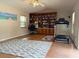 Spacious office features custom built-in shelving, laminate flooring, and an exercise area at 3761 Countryside Rd, Sarasota, FL 34233