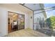 Covered patio featuring wood flooring, view of outdoor patio area, and sliding glass doors into dining area at 3761 Countryside Rd, Sarasota, FL 34233