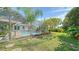 Inviting screened-in pool with lush landscaping and sunny skies at 3761 Countryside Rd, Sarasota, FL 34233