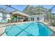 Relaxing screened pool with outdoor dining and seating areas at 3761 Countryside Rd, Sarasota, FL 34233