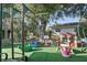 Backyard with a swing set, playset, picnic table, and artificial turf at 3941 Pin Oaks St, Sarasota, FL 34232