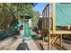 Backyard featuring a green playground with slides and climbing structures near a home at 3941 Pin Oaks St, Sarasota, FL 34232