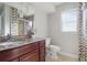Bathroom featuring a granite countertop, dark wood cabinets, patterned tile, and glass enclosed shower at 3941 Pin Oaks St, Sarasota, FL 34232