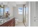 Bathroom featuring a granite countertop, dark wood cabinets, patterned tile, and glass enclosed shower at 3941 Pin Oaks St, Sarasota, FL 34232